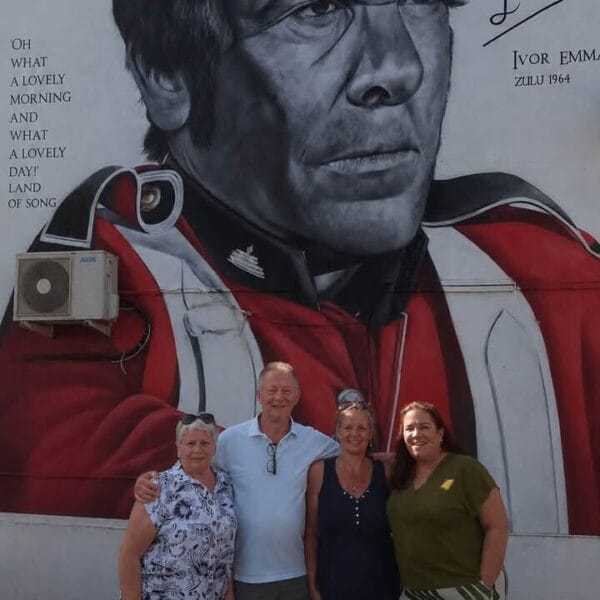 Photo of the Ivor Emmanuel mural with his daughter and family in front